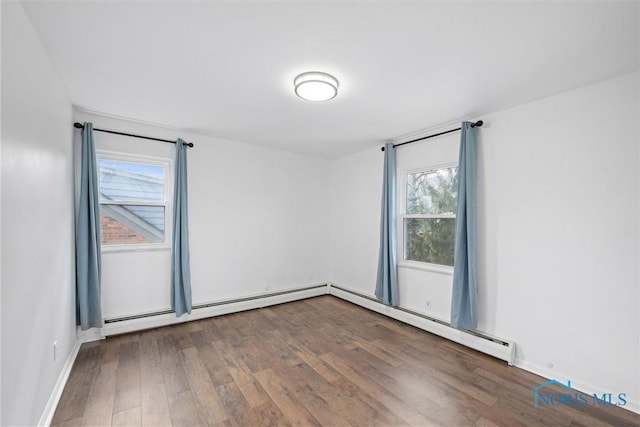 empty room featuring baseboards and wood finished floors