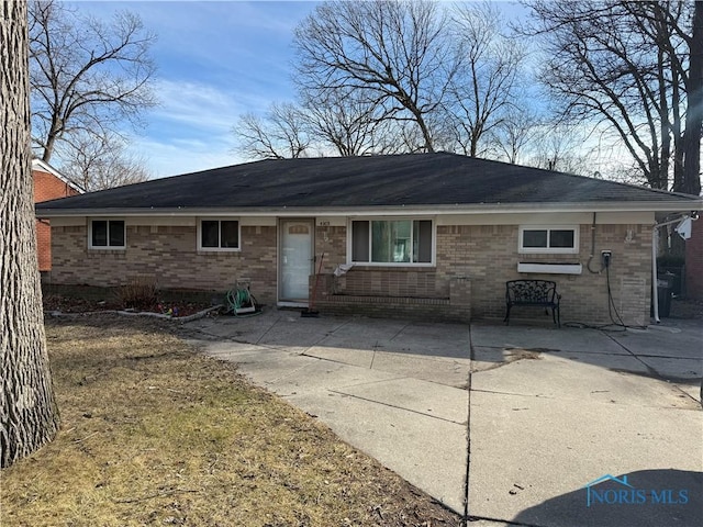 single story home featuring brick siding