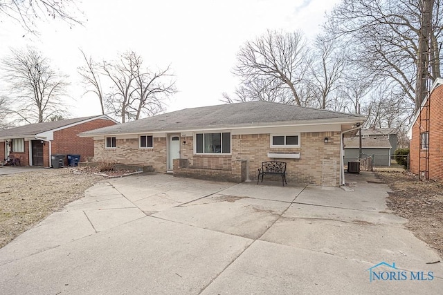 back of property with fence, brick siding, central AC, and a shingled roof