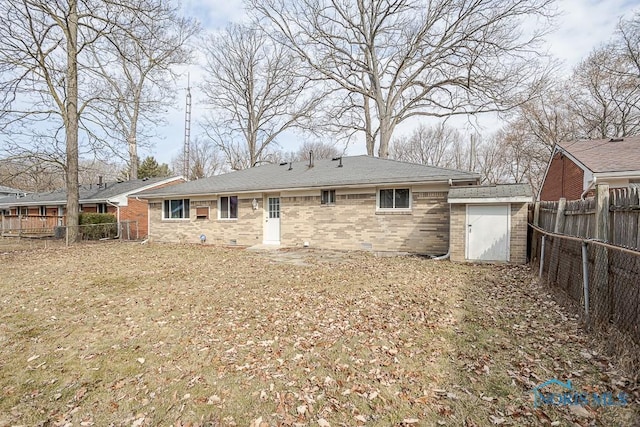 rear view of property featuring brick siding, crawl space, a fenced backyard, and roof with shingles