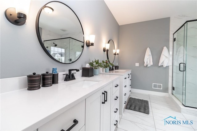 bathroom featuring vanity, visible vents, baseboards, marble finish floor, and a marble finish shower