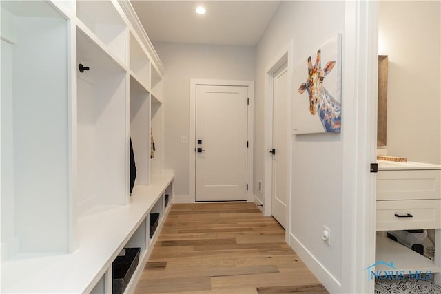 mudroom with baseboards, light wood-type flooring, and recessed lighting