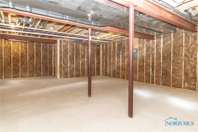 unfinished basement featuring electric panel