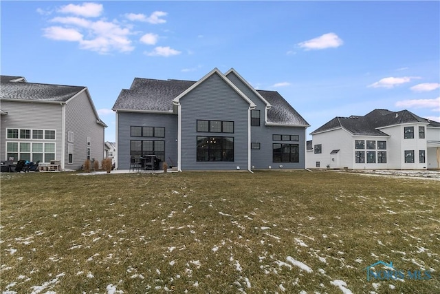 rear view of property with a yard and a patio