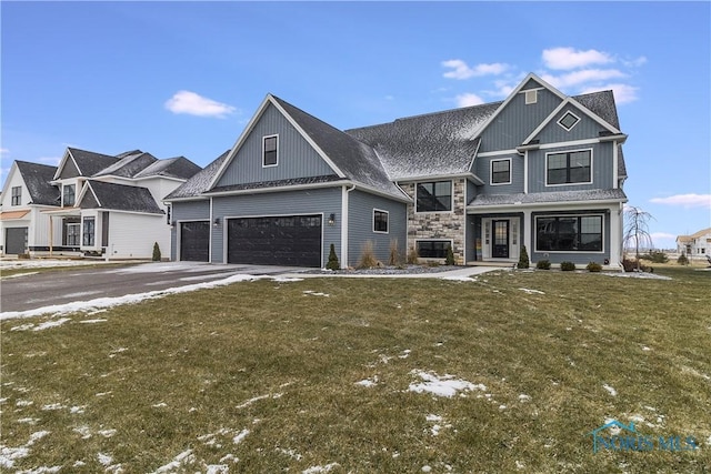 view of front facade featuring a garage, driveway, stone siding, roof with shingles, and a front lawn