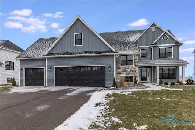 view of front of house featuring driveway, stone siding, an attached garage, and roof with shingles