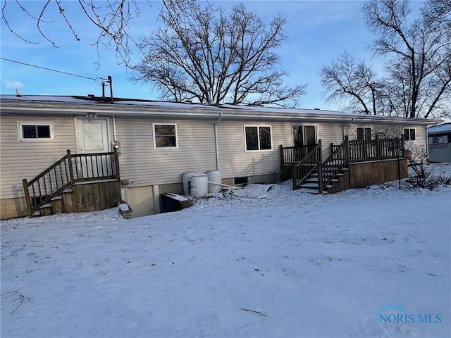 view of snow covered back of property