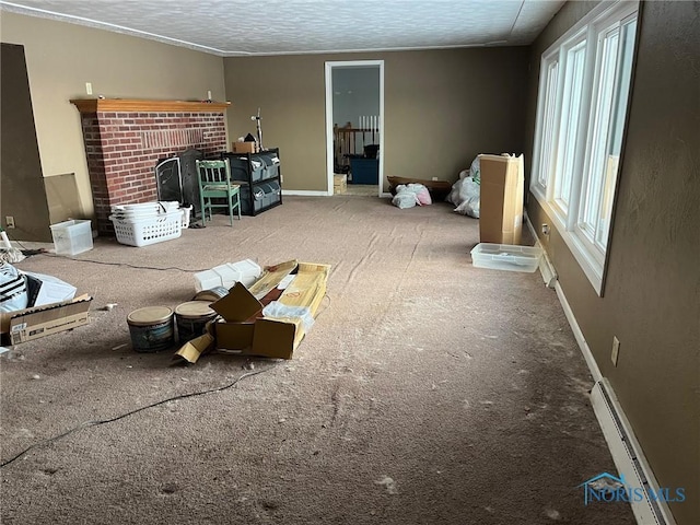 unfurnished living room featuring carpet floors, baseboard heating, a brick fireplace, a textured ceiling, and baseboards