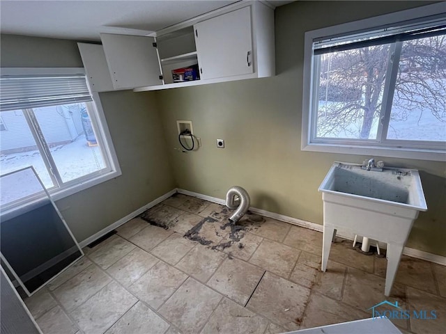 washroom featuring cabinet space, hookup for a washing machine, electric dryer hookup, and a healthy amount of sunlight