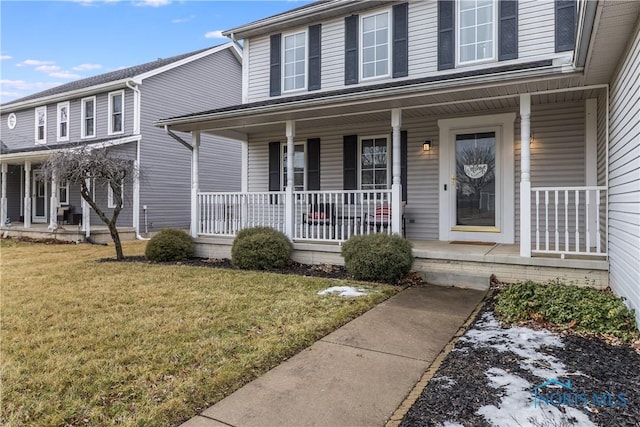 view of front of home with covered porch and a front yard