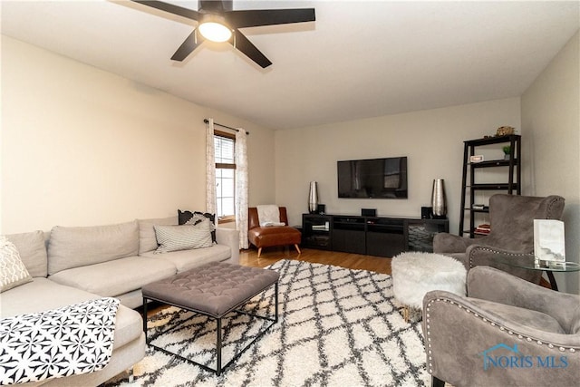 living area featuring ceiling fan and wood finished floors