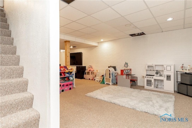 game room featuring a drop ceiling, carpet floors, and visible vents
