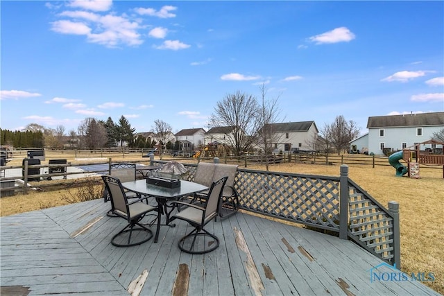 wooden terrace featuring outdoor dining area and fence