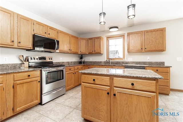 kitchen featuring light stone countertops, a kitchen island, appliances with stainless steel finishes, and hanging light fixtures