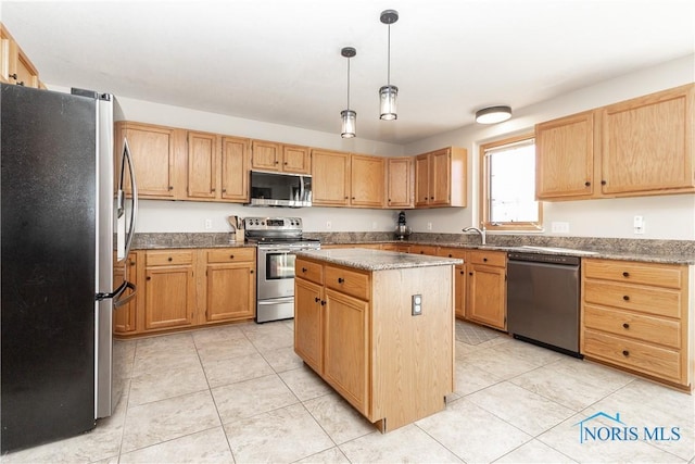 kitchen with decorative light fixtures, a kitchen island, appliances with stainless steel finishes, light tile patterned floors, and light stone countertops