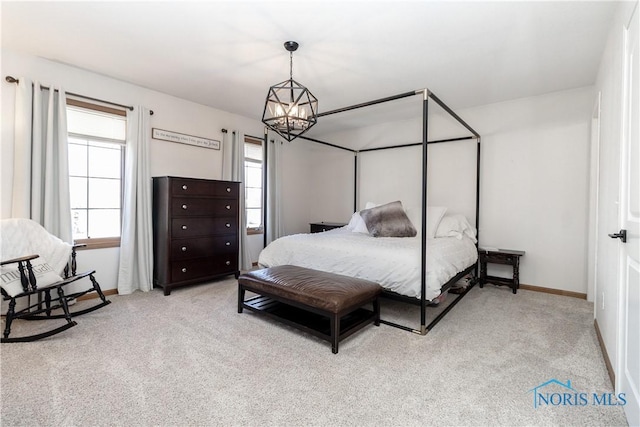 bedroom with a notable chandelier, carpet flooring, and baseboards