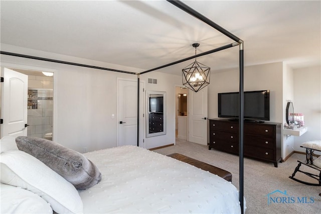 carpeted bedroom featuring a notable chandelier, visible vents, ensuite bath, and baseboards