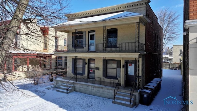 view of front of home featuring a porch and brick siding