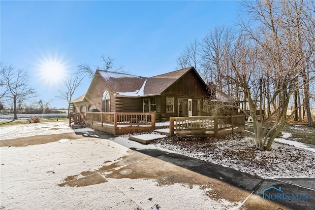 view of front of home with log exterior and a wooden deck