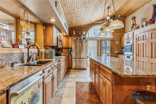 kitchen with brown cabinets, wooden ceiling, vaulted ceiling, and stainless steel appliances