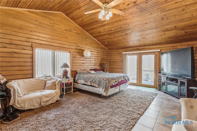 bedroom featuring access to exterior, tile patterned flooring, wood ceiling, and wooden walls