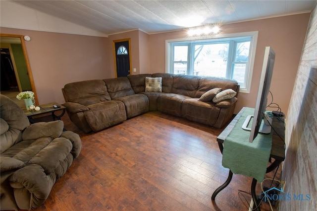 living area with ornamental molding, lofted ceiling, and wood finished floors