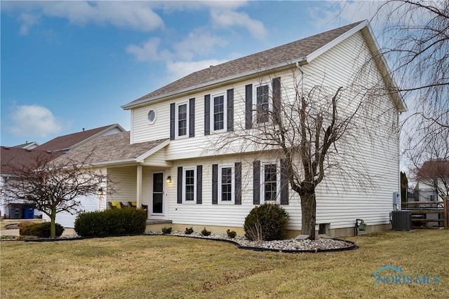 colonial house with a garage, central air condition unit, a front yard, and roof with shingles