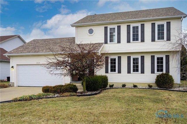 colonial inspired home with a front yard, an attached garage, driveway, and roof with shingles