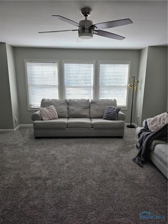 living area featuring baseboards, carpet flooring, and a healthy amount of sunlight