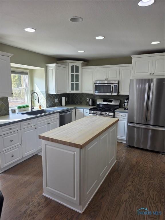 kitchen with white cabinetry, appliances with stainless steel finishes, and wooden counters