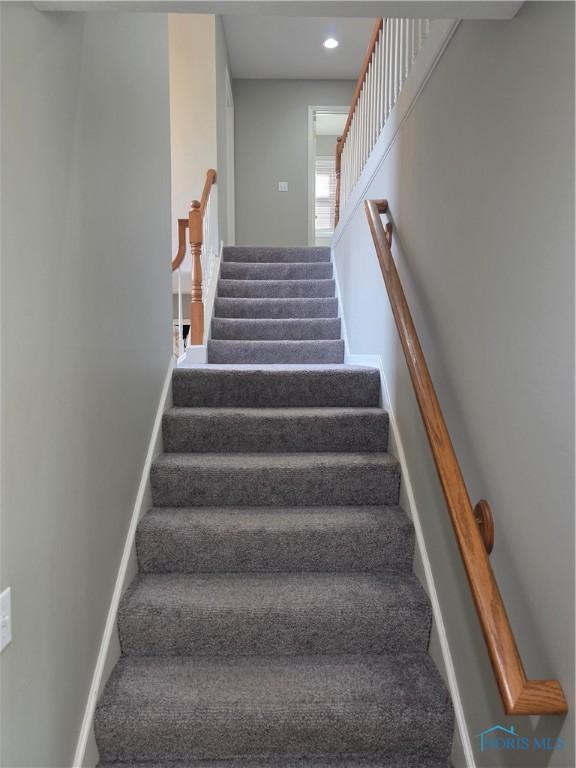 stairway with baseboards and recessed lighting