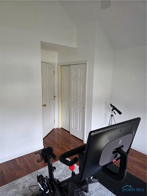 home office featuring vaulted ceiling and wood finished floors