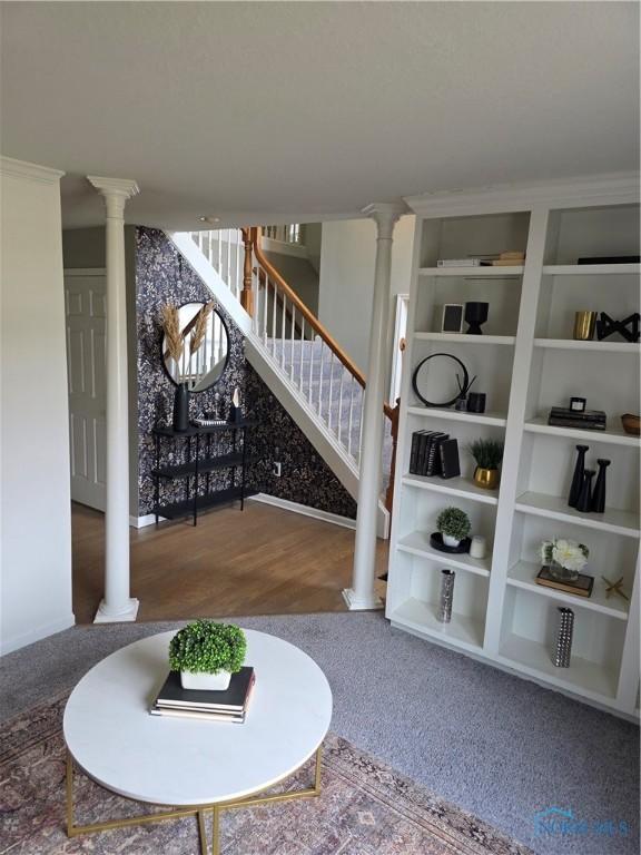 wine area featuring ornate columns and wood finished floors