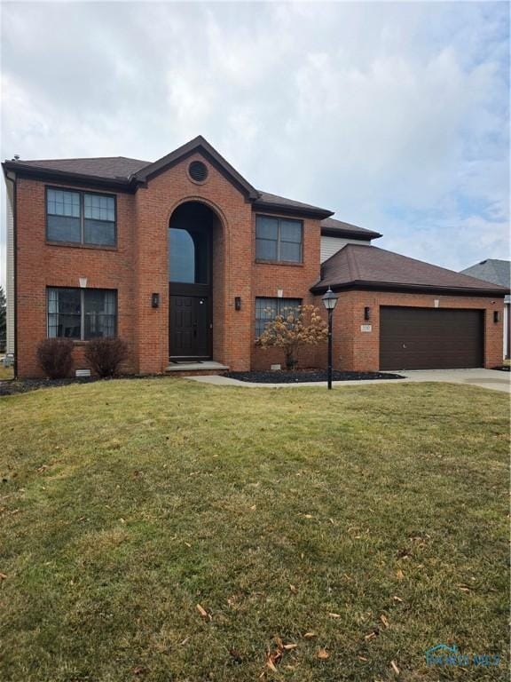 view of front facade with concrete driveway, brick siding, and a front yard