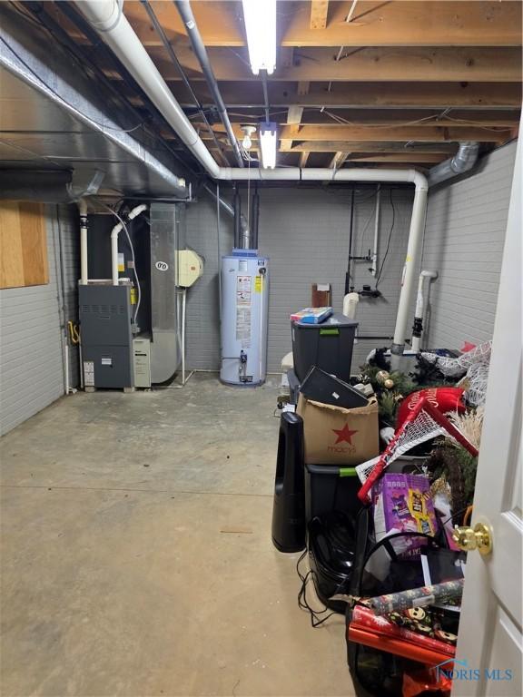 unfinished below grade area with gas water heater and heating unit