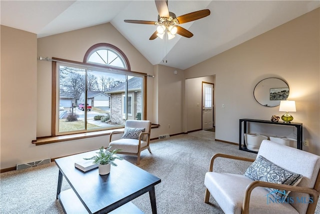 living area with vaulted ceiling, light carpet, visible vents, and baseboards