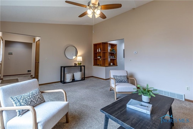 carpeted living area featuring vaulted ceiling, a ceiling fan, visible vents, and baseboards