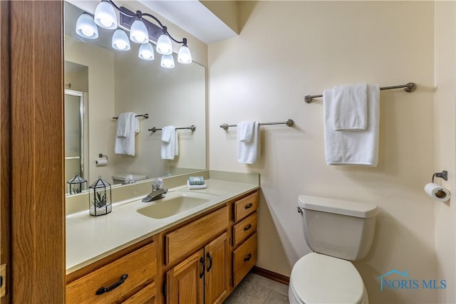 bathroom featuring baseboards, toilet, tile patterned flooring, an enclosed shower, and vanity