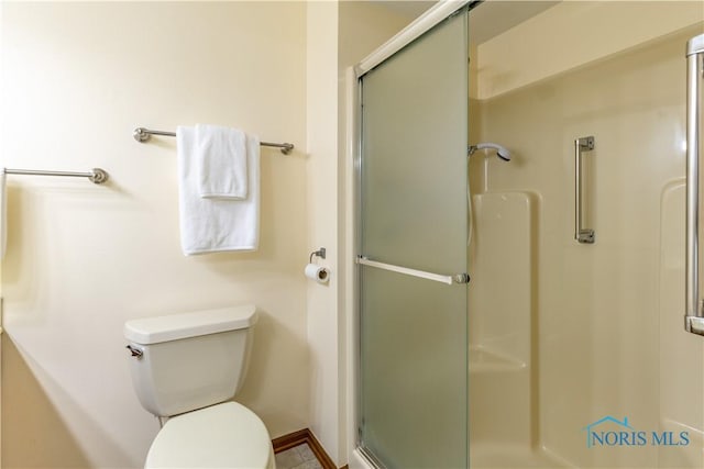 full bathroom featuring toilet and a stall shower