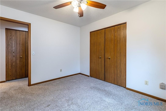 unfurnished bedroom with ceiling fan, baseboards, a closet, and carpet flooring