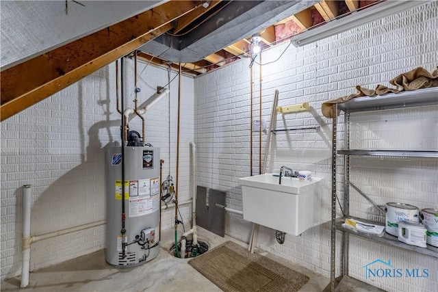 unfinished below grade area with gas water heater and a sink