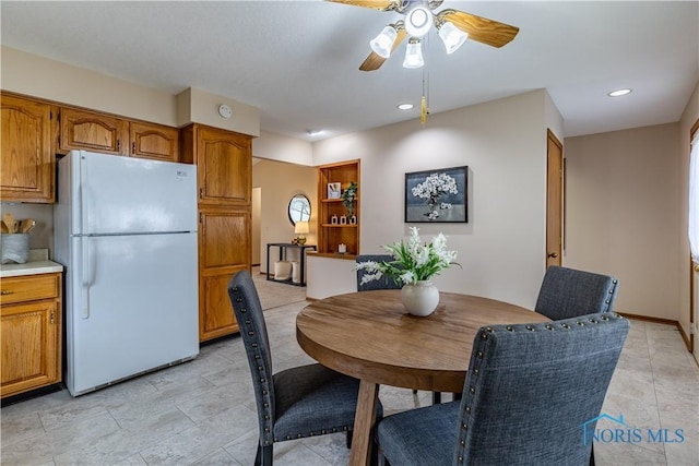 dining space with ceiling fan and recessed lighting