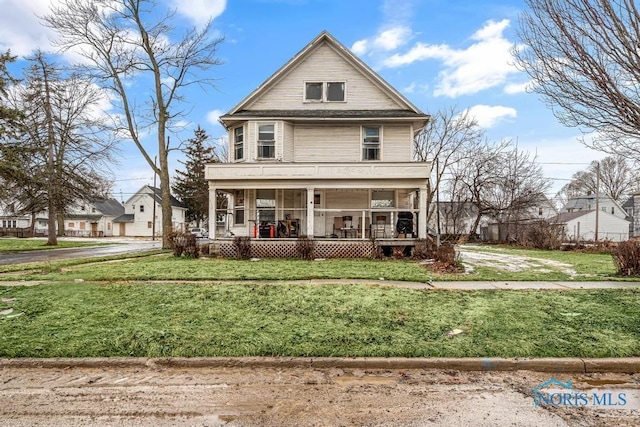 traditional style home featuring a porch and a front yard