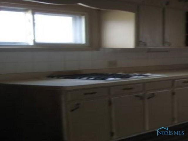 kitchen featuring white cabinetry and light countertops