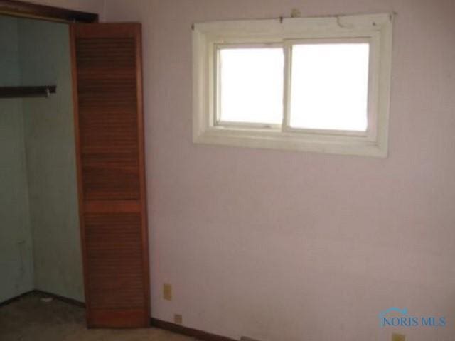 unfurnished bedroom with a barn door