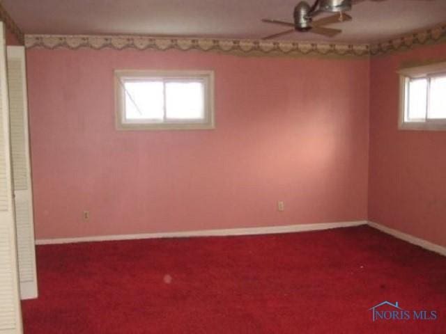 below grade area featuring carpet floors and baseboards