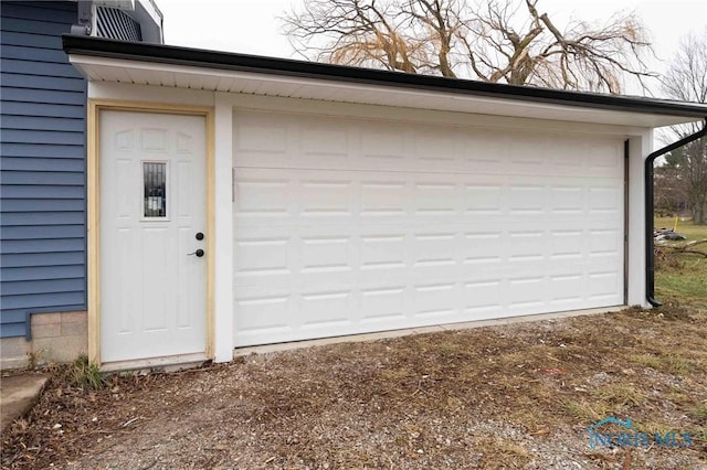 garage with dirt driveway