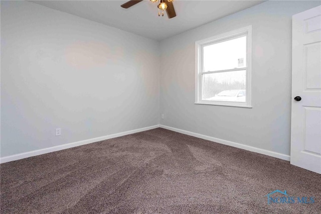 empty room with ceiling fan, carpet flooring, and baseboards