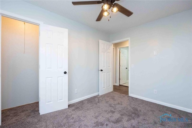 unfurnished bedroom featuring carpet floors, a ceiling fan, and baseboards