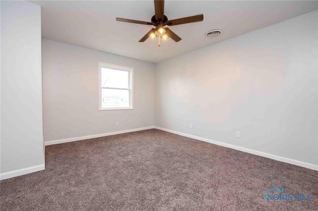 spare room featuring ceiling fan, carpet floors, visible vents, and baseboards